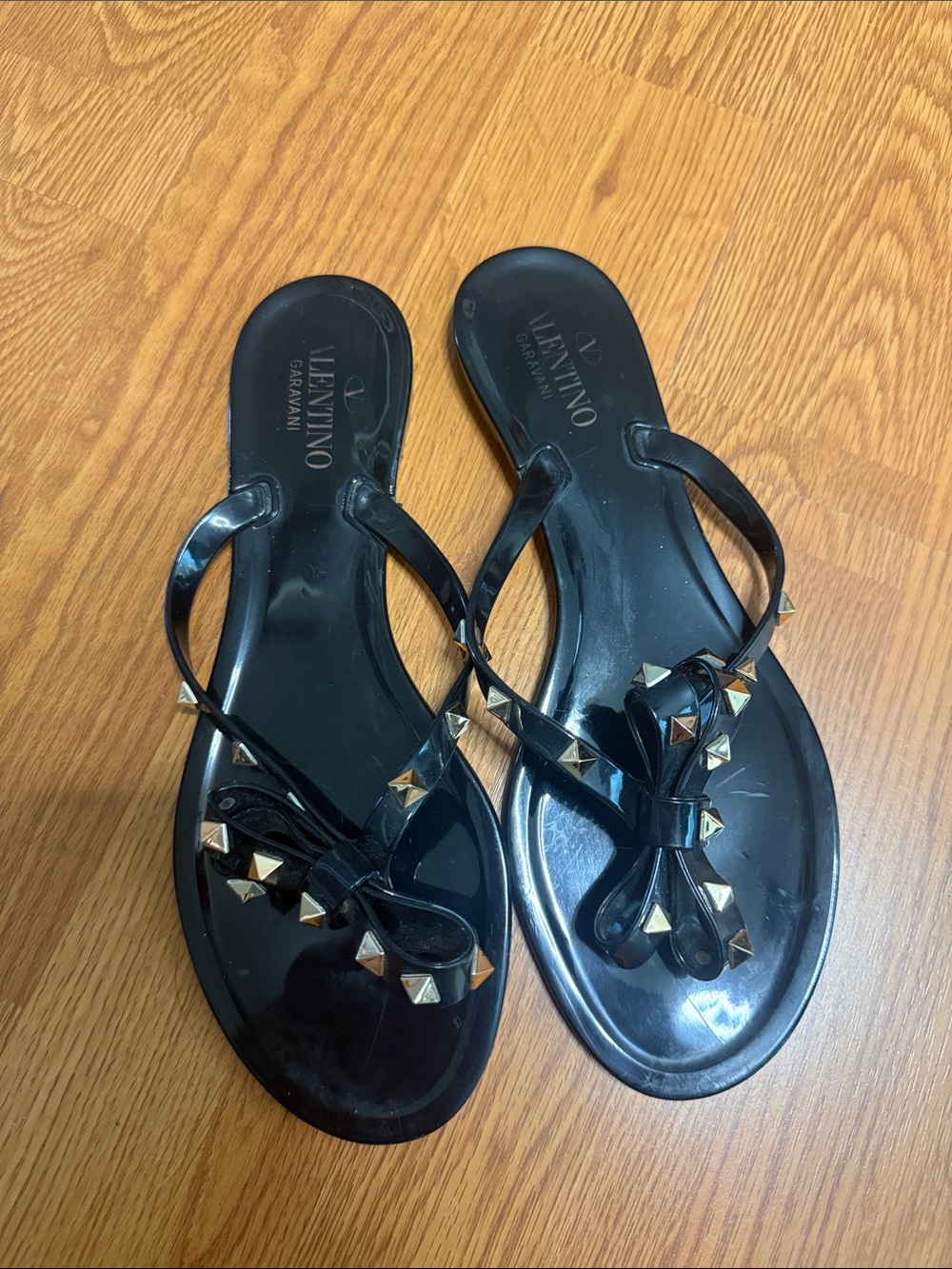 Valentino Garavani Black Jelly Bow Thong Sandals with Gold Pyramid Studs